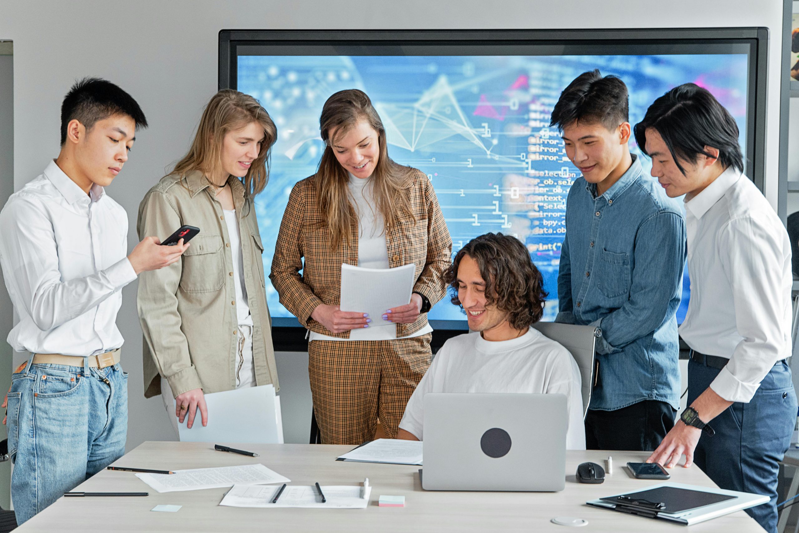 A diverse and skilled team of developers collaborating on a project in a modern office, representing a nearshore outsourcing partner.
